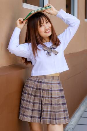 Japanese Schoolgirl School Uniform Sex - Premium Photo | Cute and young girl wearing japanese, korean style schoolgirl  uniform holding book and pose to camera with fun and happy in front of  school building.