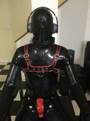 latex gimp bondage - Gimp locked into bondage chair