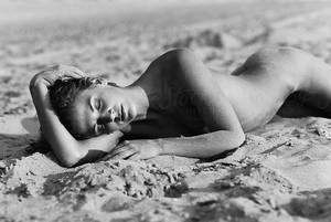 black and white pictures of people on the beach nude - young naked woman sleeping on beach by Rene de Haan for Stocksy United