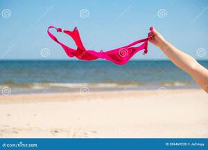 close up beach nudes - Close Up of Young Woman Taking Off Her Bra at Nude Beach. Concept of  Sunbathing Naked on the Sandy Ocean Beach Stock Photo - Image of bare, beach:  206469220