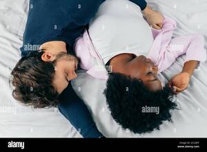 interracial couples sleeping - Close-up of happy interracial couple sleeping in bed together, enjoying the  company of each other. Comfort and relaxation Stock Photo - Alamy