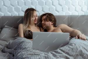 bed room - Premium Photo | Couple watching porn movie over laptop in bedroom