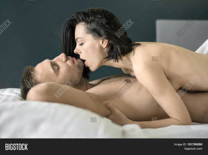 couples hot nude - Hot nude couple with closed eyes lies on the white linens on the bed. Guy