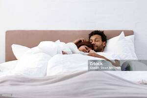 interracial couples sleeping - Interracial Couple Sleeping Together Stock Photo - Download Image Now -  Sleeping, Bed - Furniture, Couple - Relationship - iStock