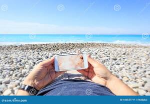 beach girls naked cam - Tourist at the Beach Watching on His Phone Stock Image - Image of blue,  screen: 106537711