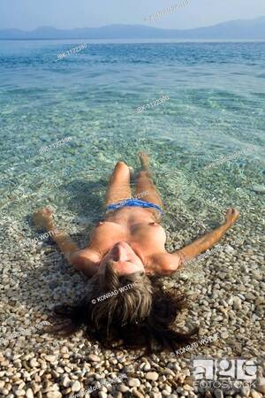 euro topless beach videos - Woman 35 years old, relaxing in the shallow water, topless, Makarska  Riviera, Dalmatia, Croatia, Stock Photo, Picture And Royalty Free Image.  Pic. IBK-1122390 | agefotostock