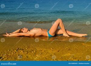 laying naked on beach gallery - Nude Girl Lying on a Sandy Beach Stock Photo - Image of topless, adult:  61089540