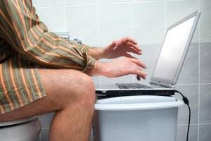 hand turn off - Man using laptop in bathroom