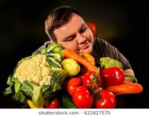 fat people eating like slobs - Diet fat man eating healthy food with vegetables cauliflower and sweet  pepper with radish , tomatoes