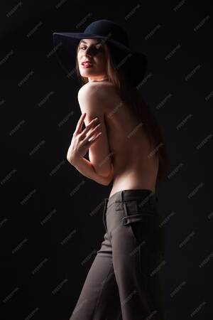 black people boobs nude - Premium Photo | Portrait of attractive young girl in black hat covering naked  breast while looking away.studio shot