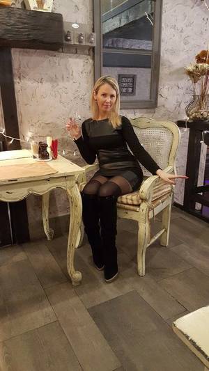 Maya Russian Milf Porn - Russian MILF woman sitting in the restaurant in a black dress