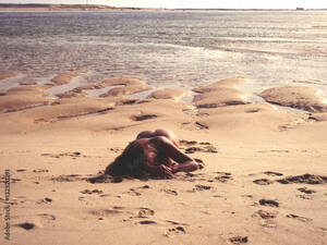 laying naked on beach gallery - Nude female lying on the on the beach in Portugal Stock Photo | Adobe Stock