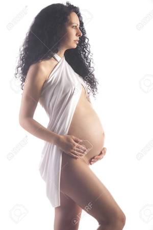 long hair pregnant nude - Portrait of a naked pregnant young woman with a visible belly and scarf  Stock Photo -