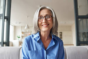 mature web cam videos - Smiling mature older woman looking at camera, webcam headshot. Stock Photo  by insta_photos