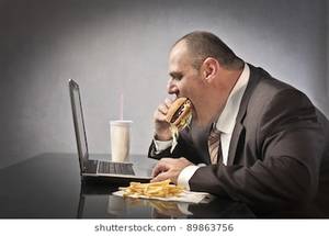 fat people eating like slobs - Fat businessman eating junk food while working