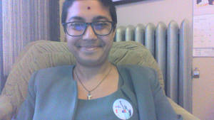 Kagito Asian Slave Porn - ... Sumana in a chair, smiling, wearing an 'I Voted' sticker