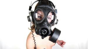 Gas Mask Girl Sexy - sexy woman with beautiful body dances with a gas mask covering her face.  Good clip