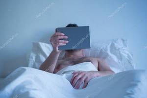 Men Masturbating While Watching Porn - Man lying in the bed , watching porn on the tablet and masturbating â€” Photo  by tommaso1979