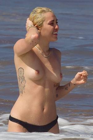 beach sex big tit hawaiian - Here is Miley Cyrus topless wearing only her bikini bottoms and enjoying  the surf at the beach in Hawaii. Miley Cyrus seems to be goin.