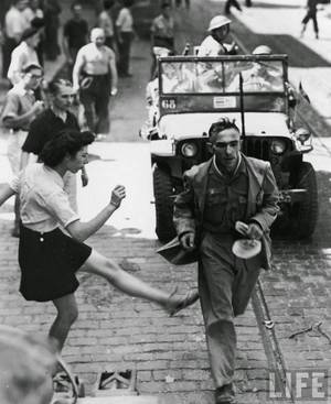 French Women Collaborators Punished Porn - WW II - French woman vents her anger towards a German POW with a kick as