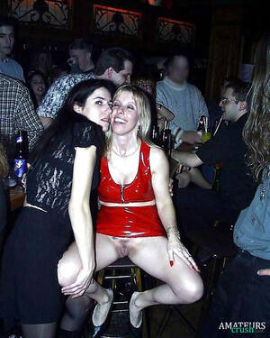 bar upskirt - upskirt milf in a bar filled with people making a picture with her friend