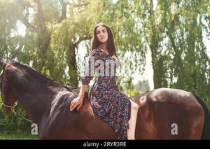 hourse latin girls nude - Young pretty latin girl laying on horseback in the forest. love animals  concept. love horses Stock Photo - Alamy