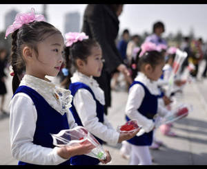 Marching Band Porn Captions - School children hold flowers on their way to pay respect to former leaders  Kim Il-