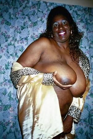 heavy black mamas - Fat mom with huge heavy melons strips nude and poses with smile on her face