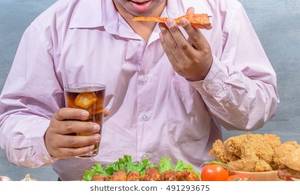 fat people eating like slobs - Fat asian businessman eat fried chicken (enjoy eating junk food concept)