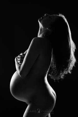 black and white nudes pregnant - A black and white photography of a pregnant, naked, caucasian woman with  long hair. The edges of her body are lit with light while the rest of her  are in ...