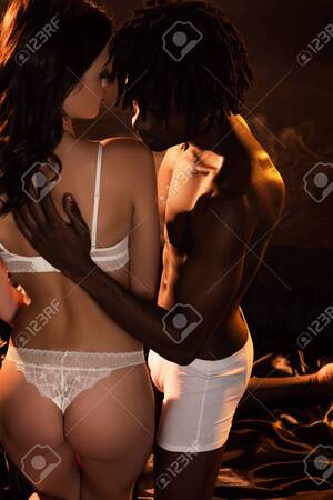 interracial couple hugging - Rear View Of Sexy Interracial Couple Hugging On Bed In Dark Stock Photo,  Picture and Royalty Free Image. Image 147969266.