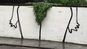 Brazilian Wax Women Porn - Humorous graffiti in London shows the contours of legs around a bush  overhanging a wall