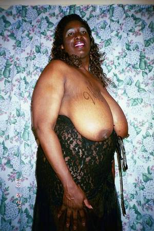 huge fat black mama - Fat mom with huge heavy melons strips nude and poses with smile on her face