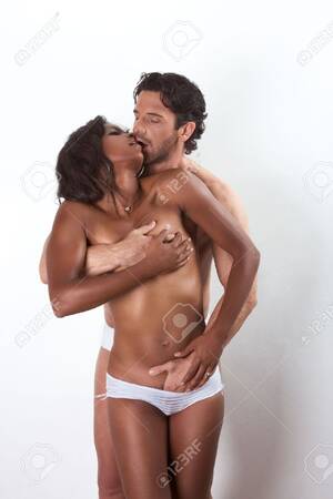 interracial kissing xxx - Loving affectionate nude interracial heterosexual couple in affectionate  sensual hugging kissing, undressing for engage in