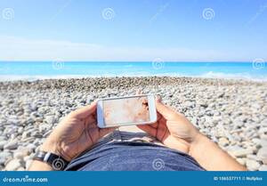 beach girls topless pageant - Tourist at the Beach Watching on His Phone Stock Image - Image of blue,  screen: 106537711