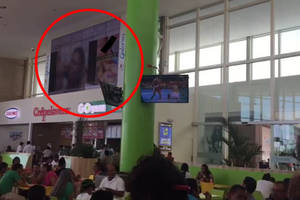 in shopping mall - Porn plays on big screen at packed shopping centre food court