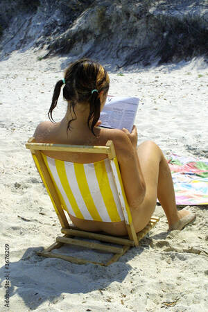 cfnm beach babes - Nude girl reading on beach Stock Photo | Adobe Stock