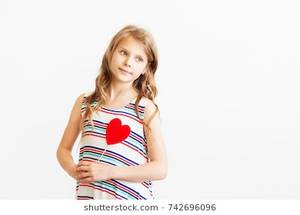 free junior tits - Closeup portrait of a lovely little girl against white background.  Beautiful teen girl holding red