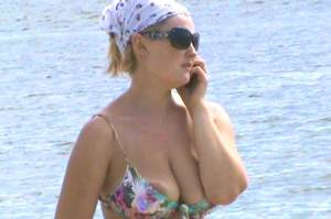 bikini oop nip slip at beach - Girl with large areola walking on the beach speaking on the phone